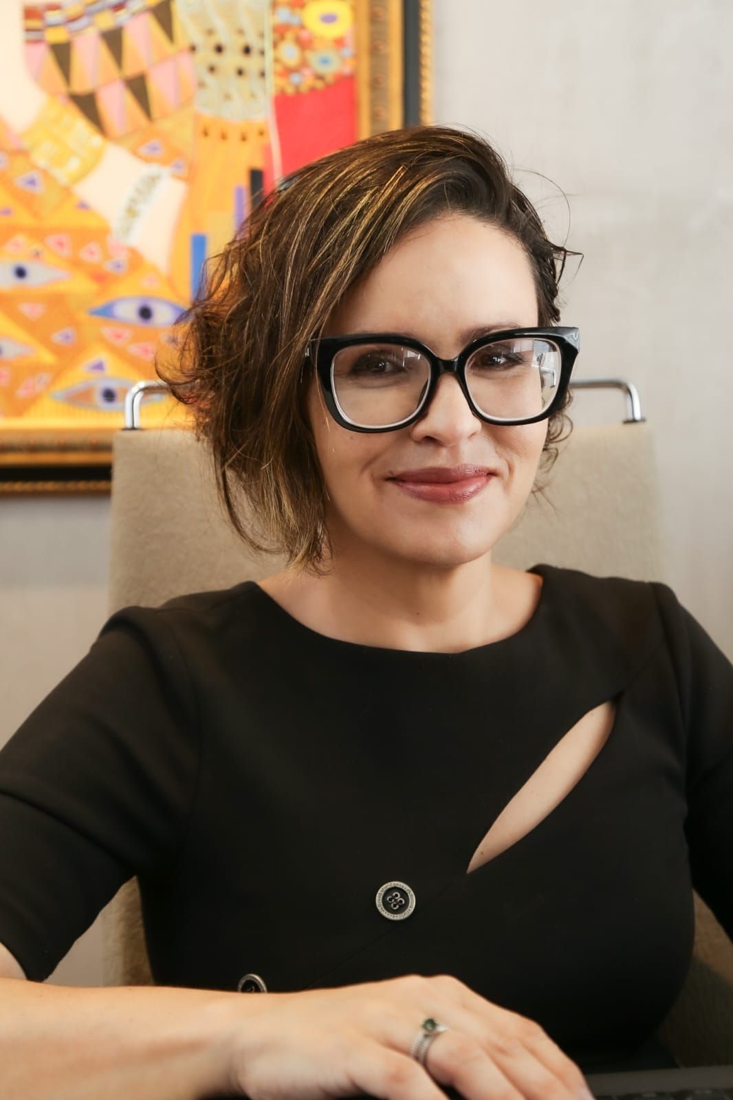 Dra. Bárbara Lenza Lana sentada à mesa do escritório